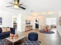 Stylishly staged living room showcasing modern decor, hardwood floors, and abundant natural light at 930 Lewis Dr, Daytona Beach, FL 32117