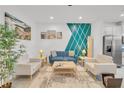 Open living area featuring a teal accent wall and comfortable seating at 1153 Seaside Mist Trl, Kissimmee, FL 34747