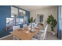 Coastal-themed dining room with a wood table and artwork at 1332 Hanoverian Dr, Lake Alfred, FL 33850