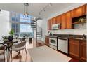 Open living room with high ceilings, spiral staircase, modern kitchen and floor-to-ceiling windows with a view at 150 E Robinson St # 1011, Orlando, FL 32801