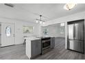 Modern kitchen island with stainless steel appliances and gray cabinets at 1527 Hernandes Dr, Orlando, FL 32808