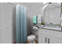 Bathroom featuring a vanity with a granite top, blue shower curtain and tile flooring at 1606 Sandy Point Sq # 53, Orlando, FL 32807