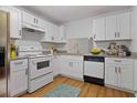 Bright kitchen featuring white cabinetry, granite countertops, and stainless steel appliances at 1606 Sandy Point Sq # 53, Orlando, FL 32807