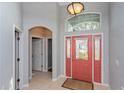 Bright entryway with coral door and tile floors at 166 Brassington Dr, Debary, FL 32713