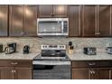 Stainless steel appliances and granite countertops in kitchen at 1721 Kona Ln, Davenport, FL 33897
