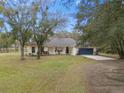 Single-story home with a large front yard and a blue garage door at 19106 Sheldon St, Orlando, FL 32833
