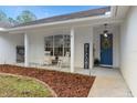 Inviting front porch with rocking chairs and a blue door at 19106 Sheldon St, Orlando, FL 32833