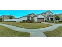 Landscaped corner lot with a one-story home and driveway at 2232 Donahue Dr, Ocoee, FL 34761