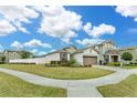 Well-maintained single Gathering home showcasing manicured lawn and inviting curb appeal on a sunny day at 2232 Donahue Dr, Ocoee, FL 34761