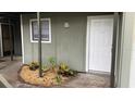 Exterior view of a house with green walls and a white door at 257 Scottsdale Sq # 257, Winter Park, FL 32792