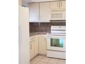 Kitchen features white appliances and light brown countertops at 257 Scottsdale Sq # 257, Winter Park, FL 32792