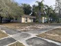 Front yard view of a single-story house with a spacious lawn at 261 Edgewood Dr, Clermont, FL 34711