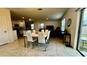 Bright dining area with white table and chairs, adjacent to kitchen at 3033 Timber Hawk Cir, Ocoee, FL 34761