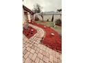 Charming home featuring a brick walkway and vibrant red mulch landscaping at 310 Blue Jacket Ln, Orlando, FL 32825