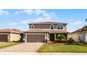 Two-story house with a two-car garage and well-manicured lawn at 351 Lazio Cir, Debary, FL 32713