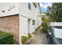 Side view of a white building with brick accents and a walkway at 488 W Par St # 4, Orlando, FL 32804