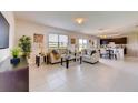 Open concept living room with tile flooring, neutral walls, and access to the kitchen at 5080 Tana Ter, St Cloud, FL 34772