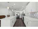 Modern white kitchen with stainless steel appliances and an island at 5703 Se 109Th St, Belleview, FL 34420