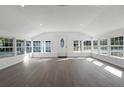 Bright and spacious living room with large windows and wood floors at 5703 Se 109Th St, Belleview, FL 34420
