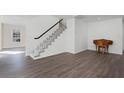 Elegant staircase with white railing and wood flooring at 5703 Se 109Th St, Belleview, FL 34420