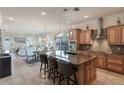 Spacious kitchen with island, stainless steel appliances, and wood cabinets at 675 Overspin Dr, Winter Park, FL 32789