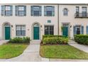 Three-unit townhouse building with green doors and landscaping at 711 Centervale Dr # 711, Celebration, FL 34747