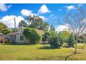 House with a manicured lawn and mature trees at 805 Wingo St, Orlando, FL 32803