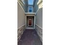 Welcoming entryway with a red brick path and stone accents leading to a modern front door with glass panel at 9088 Ocean Tide Way, Kissimmee, FL 34747