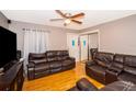 Living room with two leather sofas and hardwood floors at 6655 Durango Ct, Orlando, FL 32809