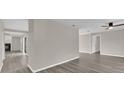 Open living area with gray walls, wood-look floors, and views to other rooms at 10842 Sw 67Th Ave, Ocala, FL 34476
