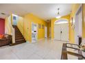 Bright entryway with tile floors and a staircase leading upstairs at 111 Vista Dr, Davenport, FL 33897