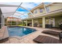 Inviting pool area with a screened enclosure and patio furniture at 111 Vista Dr, Davenport, FL 33897