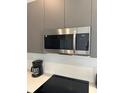 Stainless steel microwave and electric cooktop in a modern kitchen at 1431 Serendipity Ln, Clermont, FL 34714