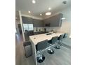 Modern kitchen with stainless steel appliances and an island with seating at 1431 Serendipity Ln, Clermont, FL 34714