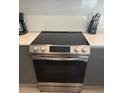 Stainless steel oven and electric cooktop in modern kitchen at 1431 Serendipity Ln, Clermont, FL 34714