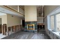 Spacious living room with hardwood floors and a large fireplace at 1450 Warrior Trl, Deltona, FL 32725