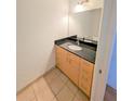 Modern bathroom with dark countertop and light wood cabinets at 150 E Robinson St # 1411, Orlando, FL 32801