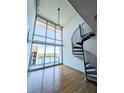 Bright loft living area with hardwood floors, spiral staircase, and stunning water views at 150 E Robinson St # 1411, Orlando, FL 32801