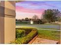 Charming backyard view with pond and fountain at sunset at 15336 Firelight Dr, Winter Garden, FL 34787