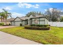 Charming single-story home with a lush green lawn and well-manicured landscaping at 15336 Firelight Dr, Winter Garden, FL 34787