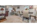 Living room with sectional sofa, dining table, and hardwood floors at 3829 Arborvitae Way, Deland, FL 32724
