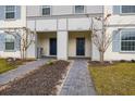 Two townhouses share an entryway with paver walkways and landscaping at 4298 Lana Ave, Davenport, FL 33897