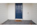 Modern blue front door with a welcome mat at 4298 Lana Ave, Davenport, FL 33897