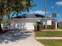 Front view of a single-story home with a two-car garage at 4715 Ainsdale Walk, Kissimmee, FL 34746