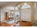 Elegant entryway with hardwood floors, columns, and formal dining area at 5521 Hogan Ln, Winter Haven, FL 33884