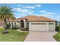 One-story house with a light brown roof and a brick driveway at 5521 Hogan Ln, Winter Haven, FL 33884