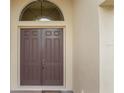 Double front doors with arched window, welcoming entryway at 5521 Hogan Ln, Winter Haven, FL 33884