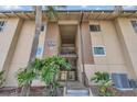 Entrance to a tan multi-unit building with stairs and landscaping at 570 Orange Dr # 54, Altamonte Springs, FL 32701