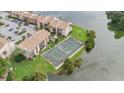 Tennis court located near a lake in a condo community at 570 Orange Dr # 54, Altamonte Springs, FL 32701