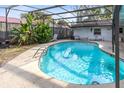 Inviting kidney-shaped pool with screened enclosure at 719 Dawson Ave, Orlando, FL 32825